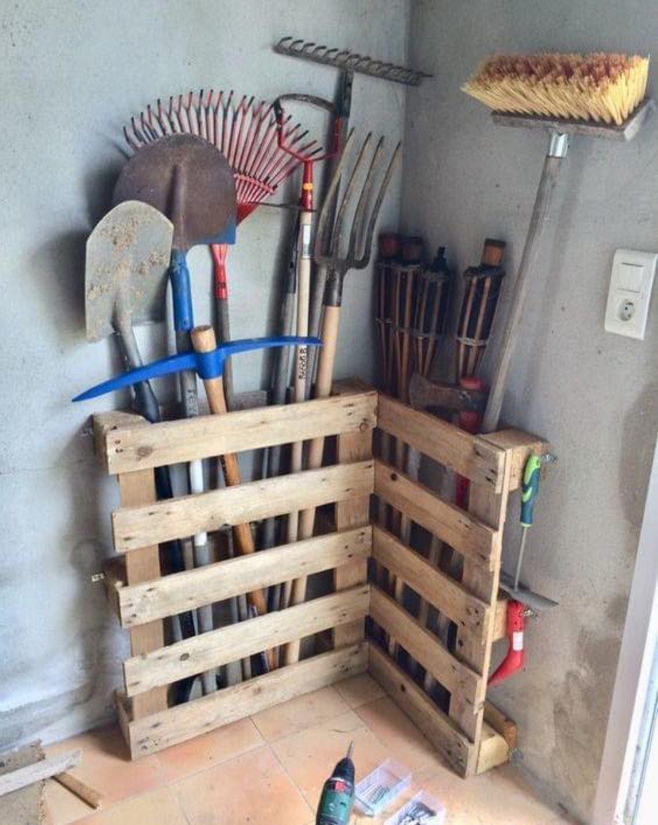 Garage Storage for Lawn Equipment: 7 Ideas That Actually Fit 3 Garden tools like shovels and rakes stored in a DIY wooden pallet rack in a corner.