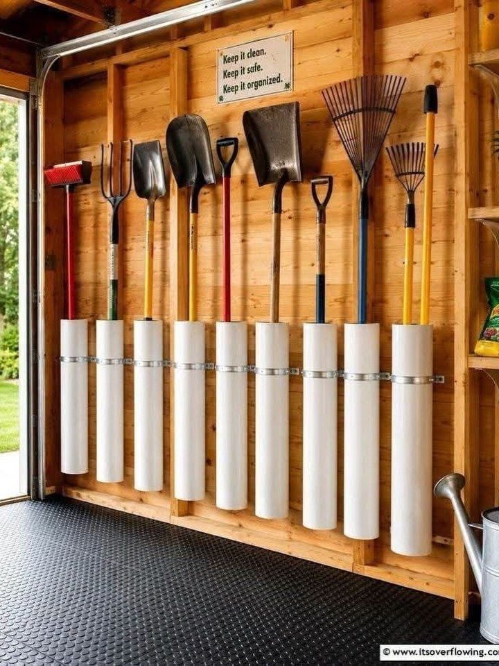 Garage Storage for Lawn Equipment: 7 Ideas That Actually Fit 7 Garden tools hanging in white cylindrical holders on a wooden garage wall.