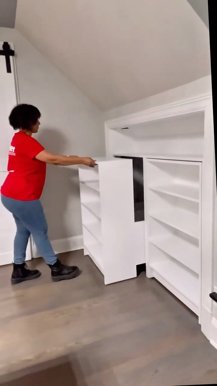 9 Hidden Storage Wall Ideas for a Cleaner Home 8 A person moving a white shelving unit into a built-in wall storage nook.