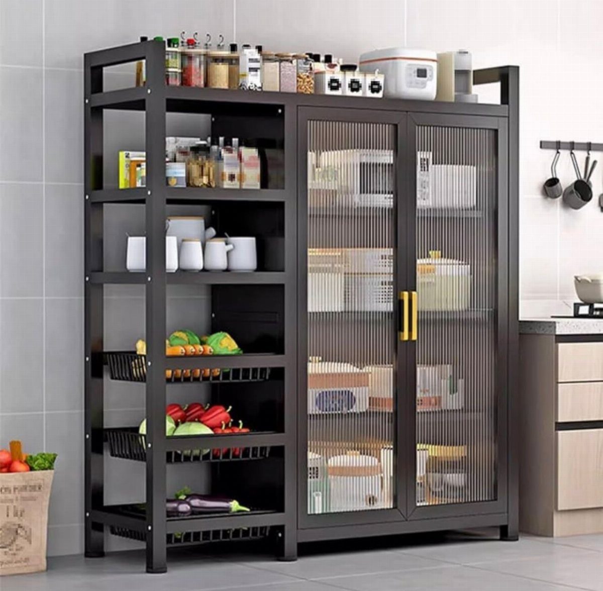 A dark metal kitchen storage cabinet with open shelves and glass doors holding various pantry items.