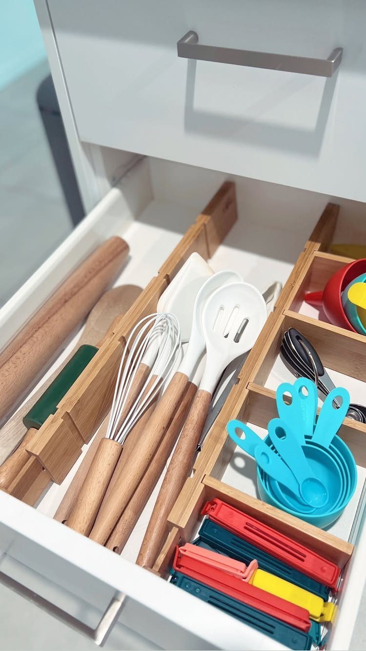 9 Kitchen Tools Organization Ideas for Cabinets, Drawers & Walls 4 Wooden dividers organize various kitchen utensils inside an open white drawer.