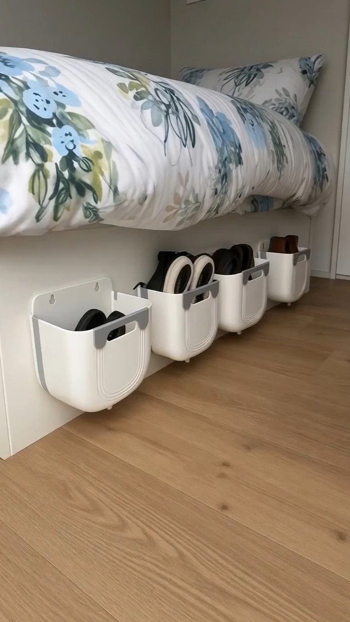 RV Shoe Storage: 6 Ideas That Save Space and Sanity 3 White wall-mounted shoe holders attached to a bed frame holding several pairs of shoes.