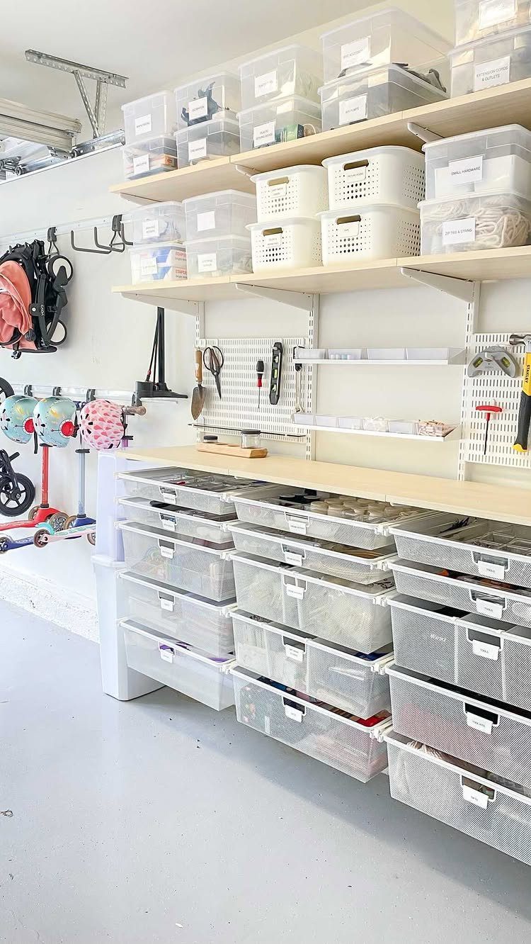 14 Shed Organization Ideas for a Tidy, Functional Space 10 Organized garage storage with clear bins on shelves, a pegboard, and a workbench area.