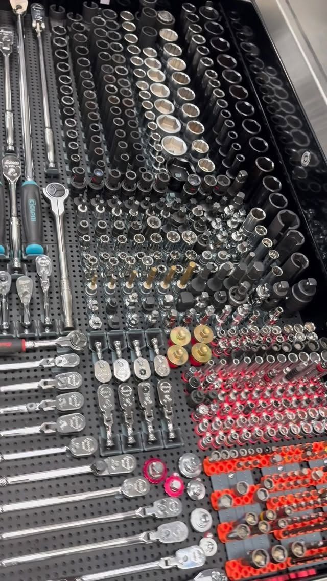 14 Shed Organization Ideas for a Tidy, Functional Space 6 Various metal wrenches and sockets organized neatly within a black foam tool drawer.