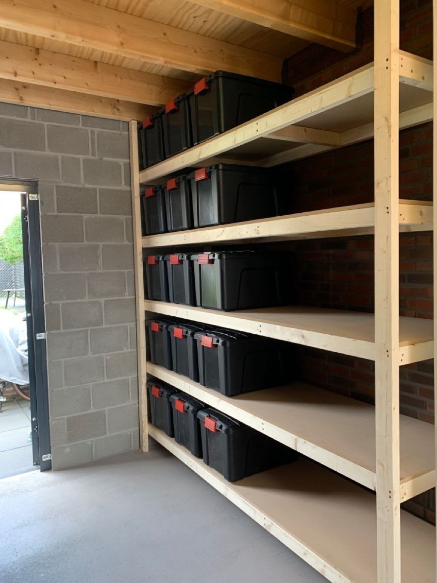 14 Shed Organization Ideas for a Tidy, Functional Space 15 Wooden shelves filled with black storage bins inside a organized concrete floor shed.