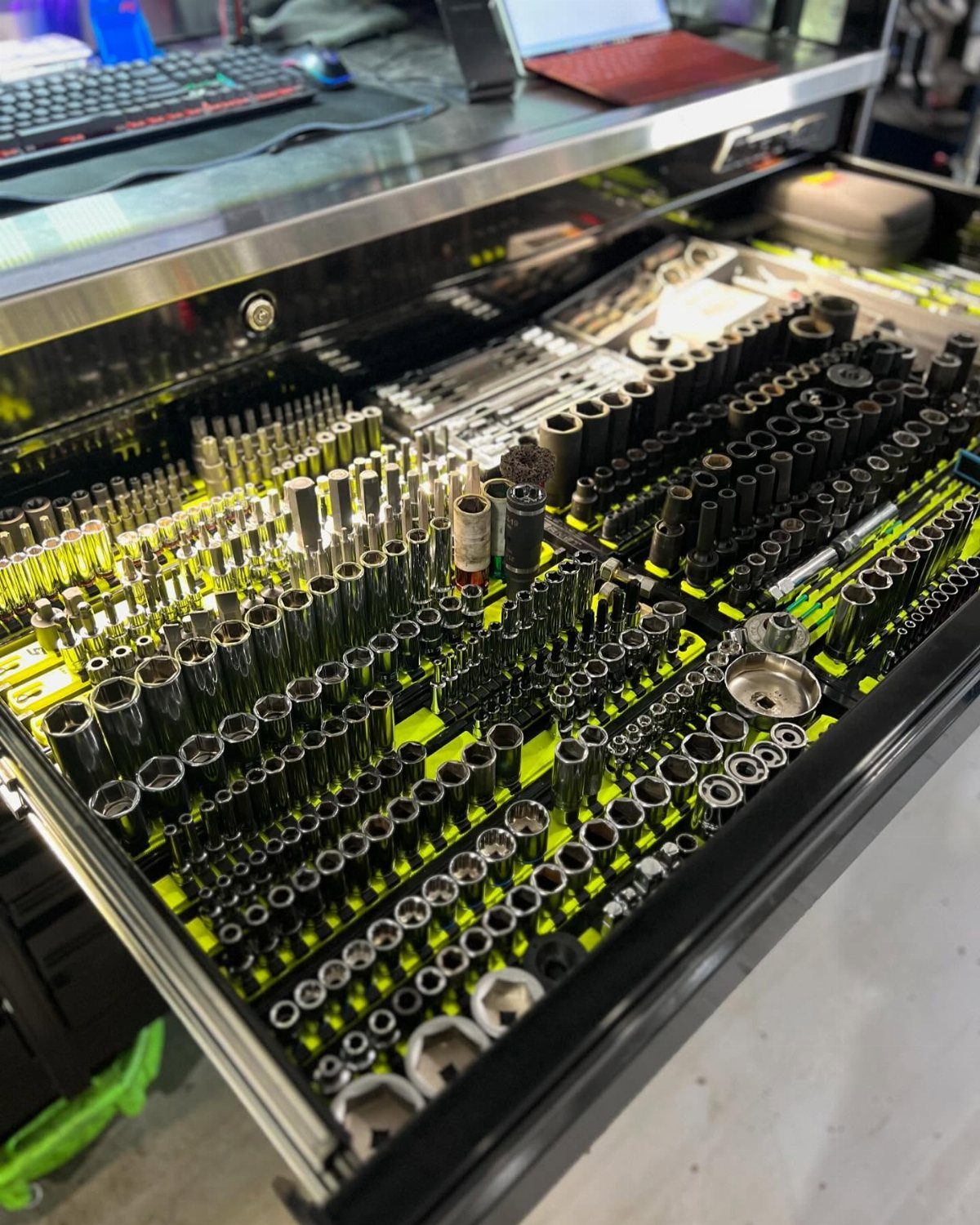 13 Shop Tool Storage Ideas for Pegboard, Carts and Cabinets 10 Metal sockets and hand tools organized in lime green foam drawer organizers inside a tool chest.