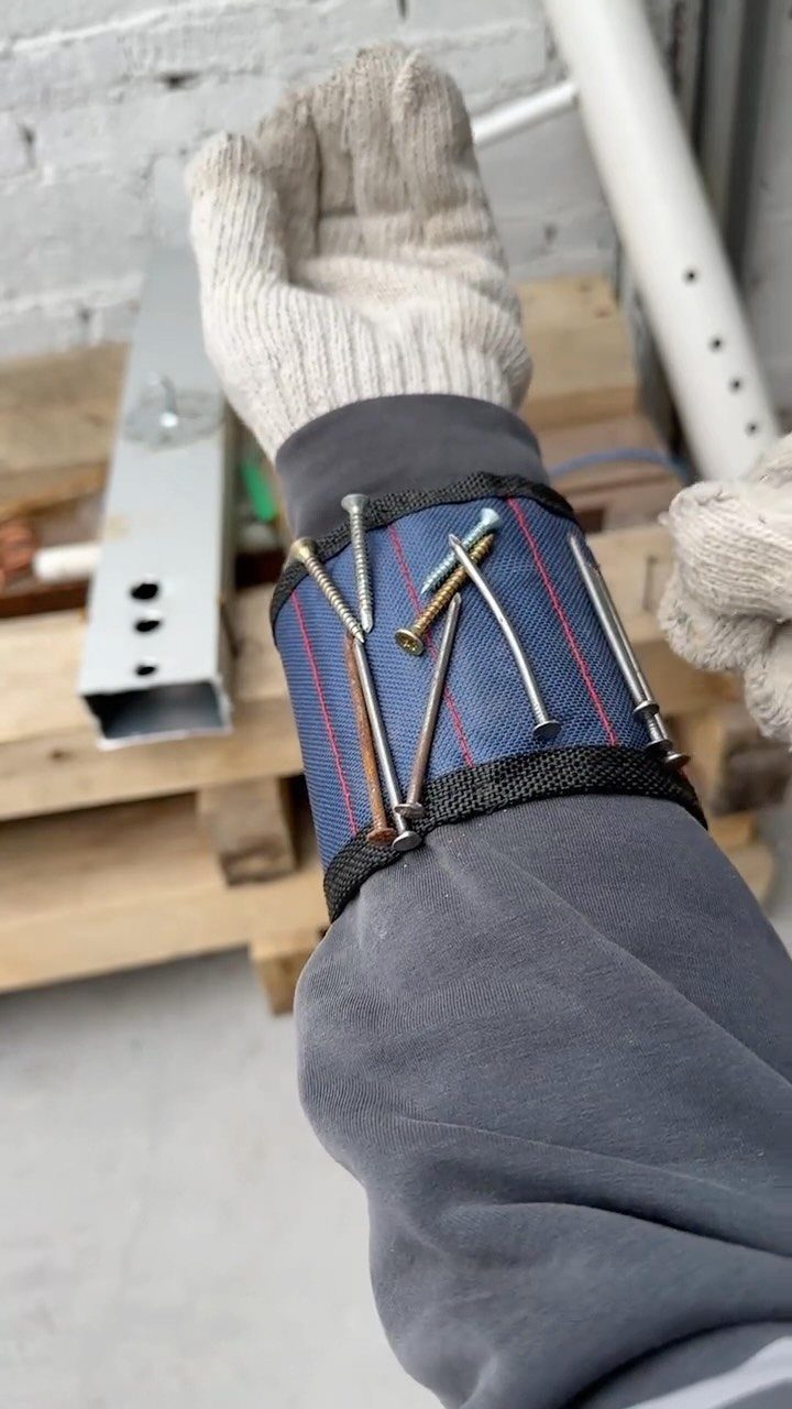13 Shop Tool Storage Ideas for Pegboard, Carts and Cabinets 12 A person wearing a blue wristband holding various metal nails and screws for easy access.