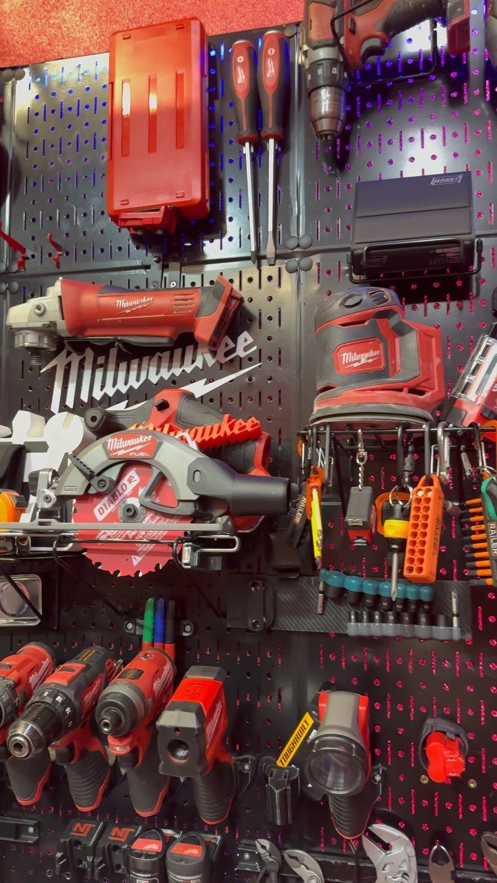 13 Shop Tool Storage Ideas for Pegboard, Carts and Cabinets 2 Various red and black Milwaukee power tools organized on a black pegboard wall storage system.