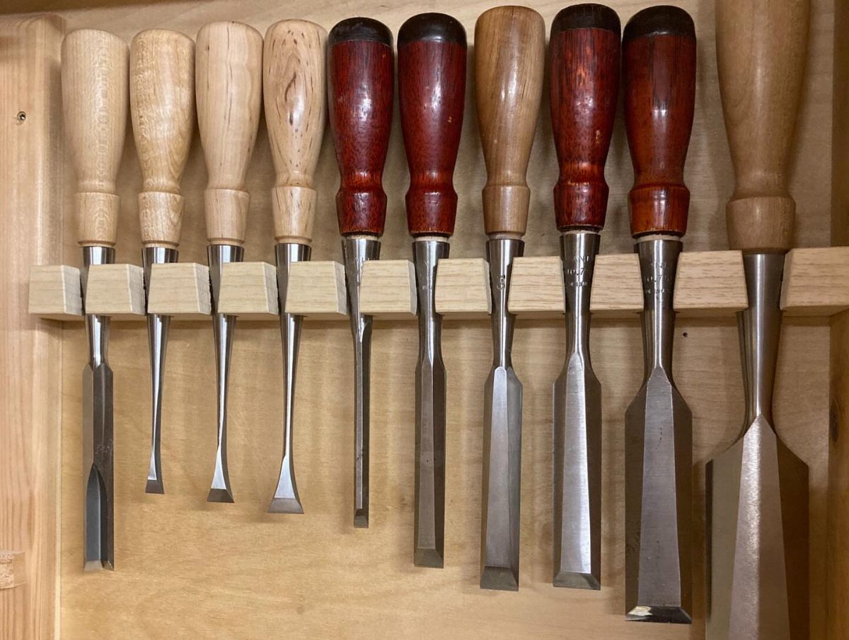 13 Shop Tool Storage Ideas for Pegboard, Carts and Cabinets 14 Woodworking chisels with various wooden handles organized in a custom wooden storage rack.
