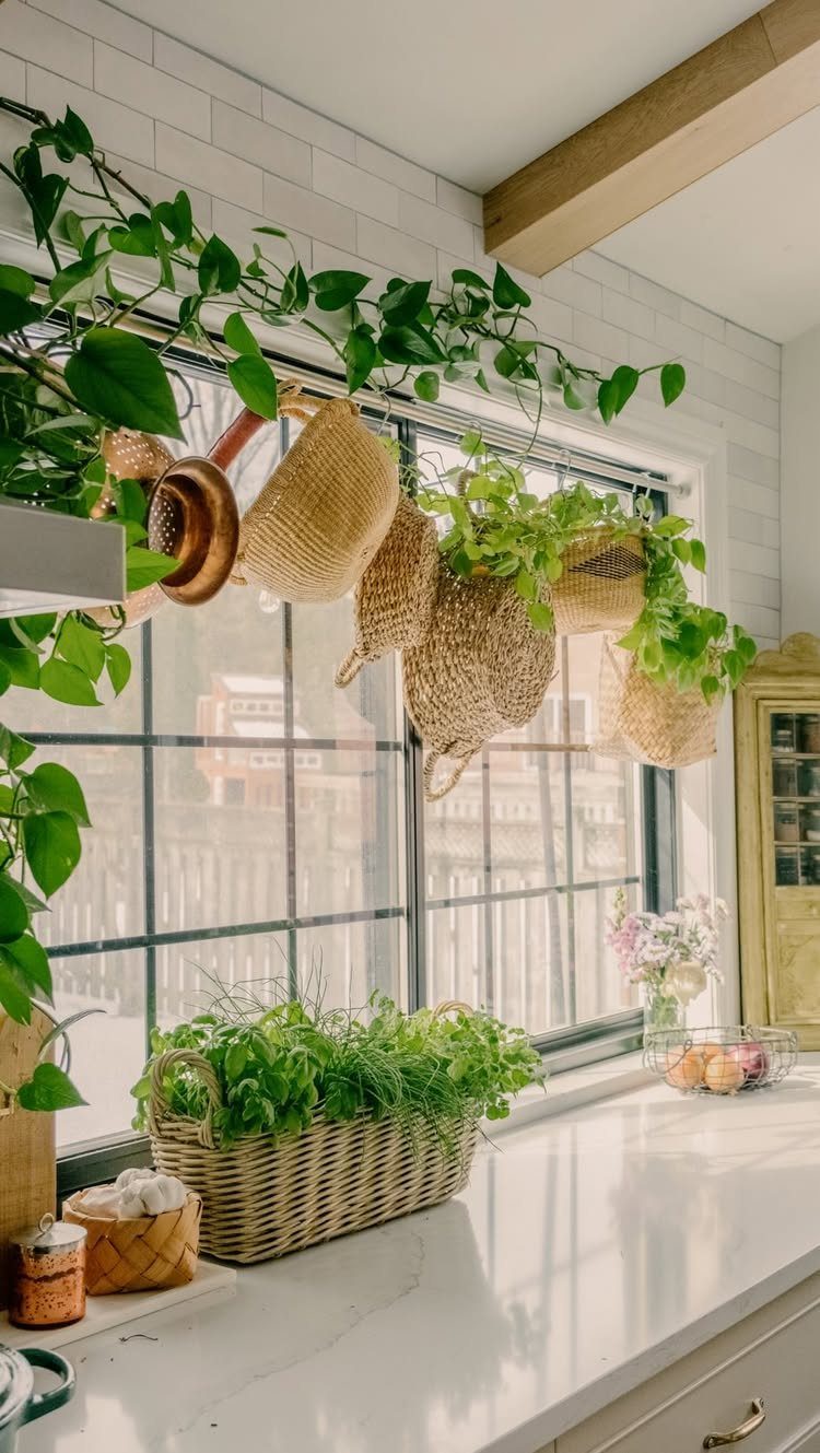 18 Small Kitchen Remodel Ideas to Open Up Your Space 12 Woven baskets and a copper pot hanging from a tension rod in front of a window.