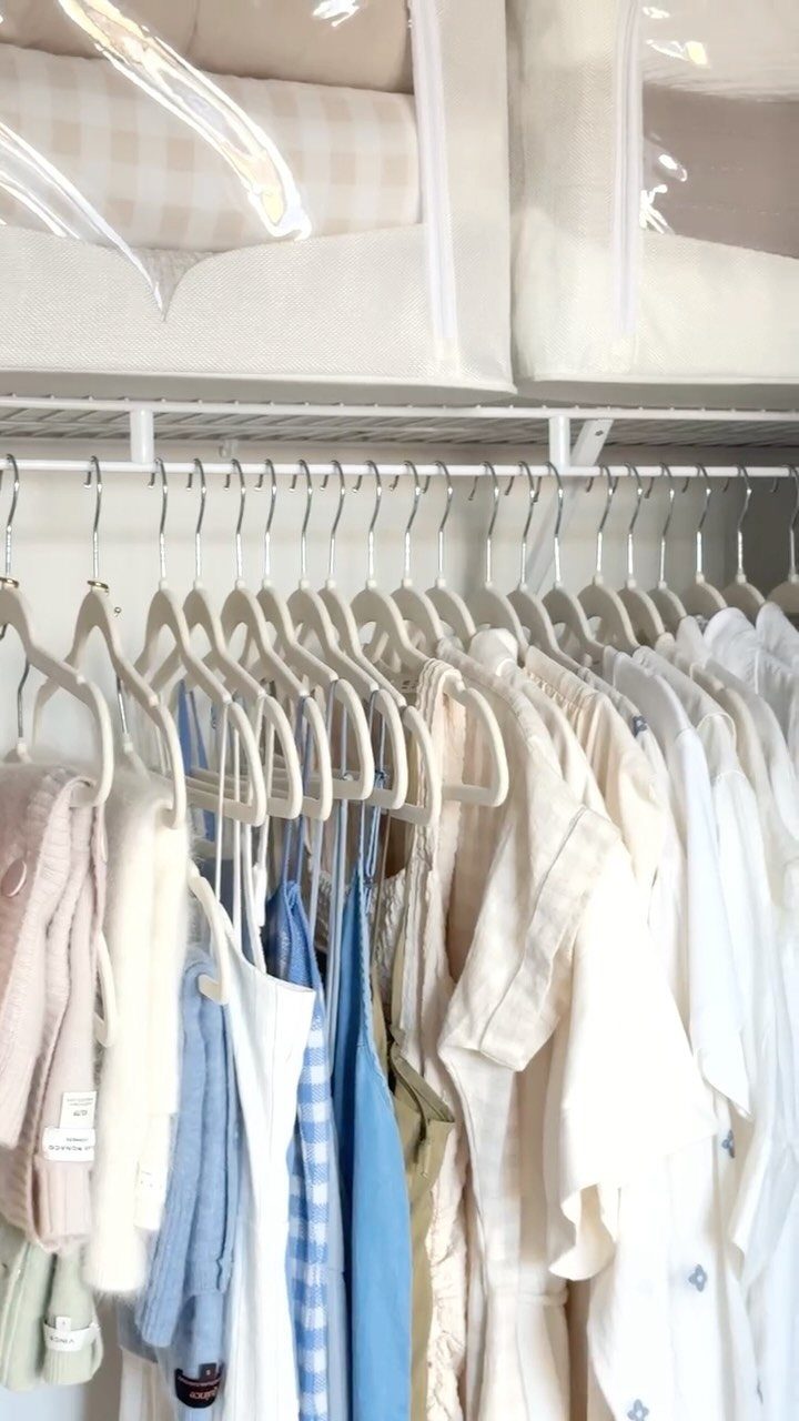 12 Storage Ideas for Small Homes to Add Extra Space Fast 2 White slim hangers holding light-colored clothes on a closet rod with storage bins above.