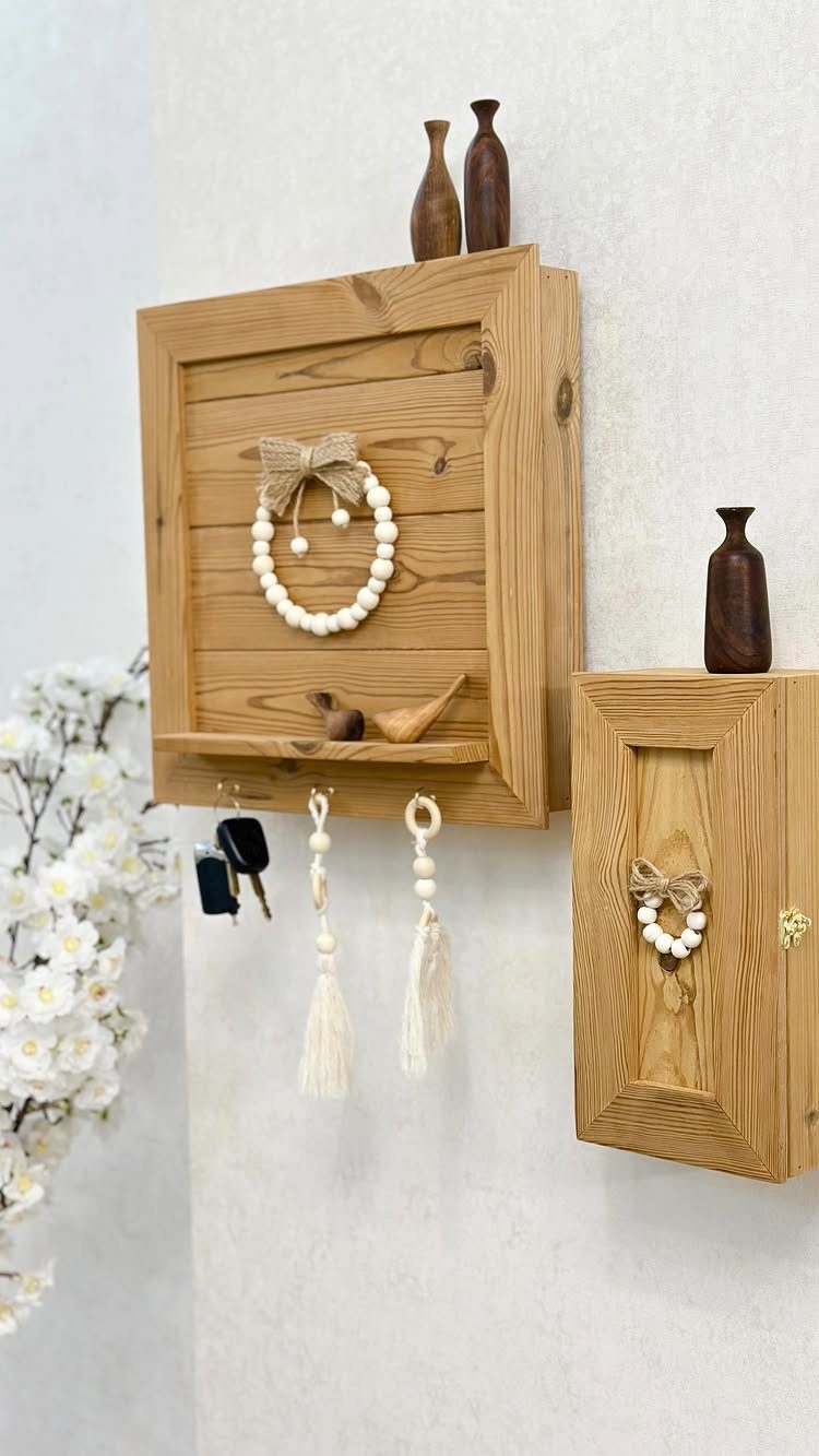 12 Storage Ideas for Small Homes to Add Extra Space Fast 5 Wooden wall-mounted organizers with small shelves, hooks, and decorative items hanging on a white wall.