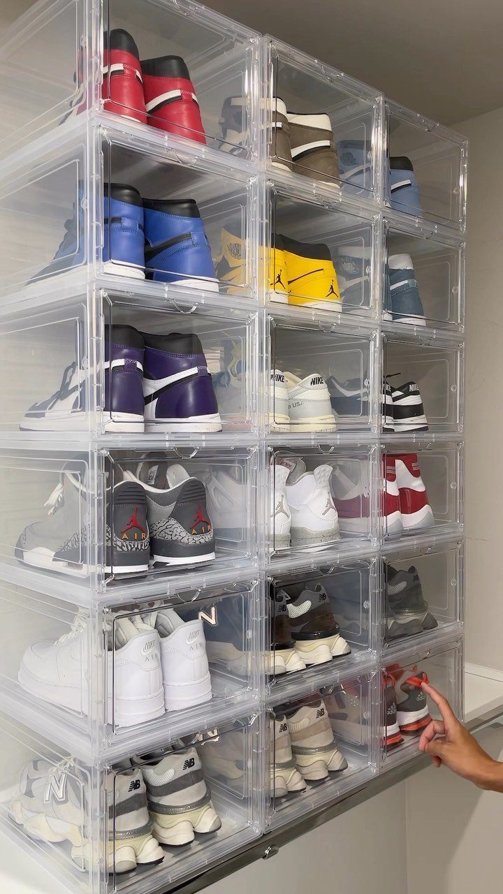 12 Storage Ideas for Small Homes to Add Extra Space Fast 12 Clear plastic storage boxes filled with colorful sneakers stacked vertically against a white wall.