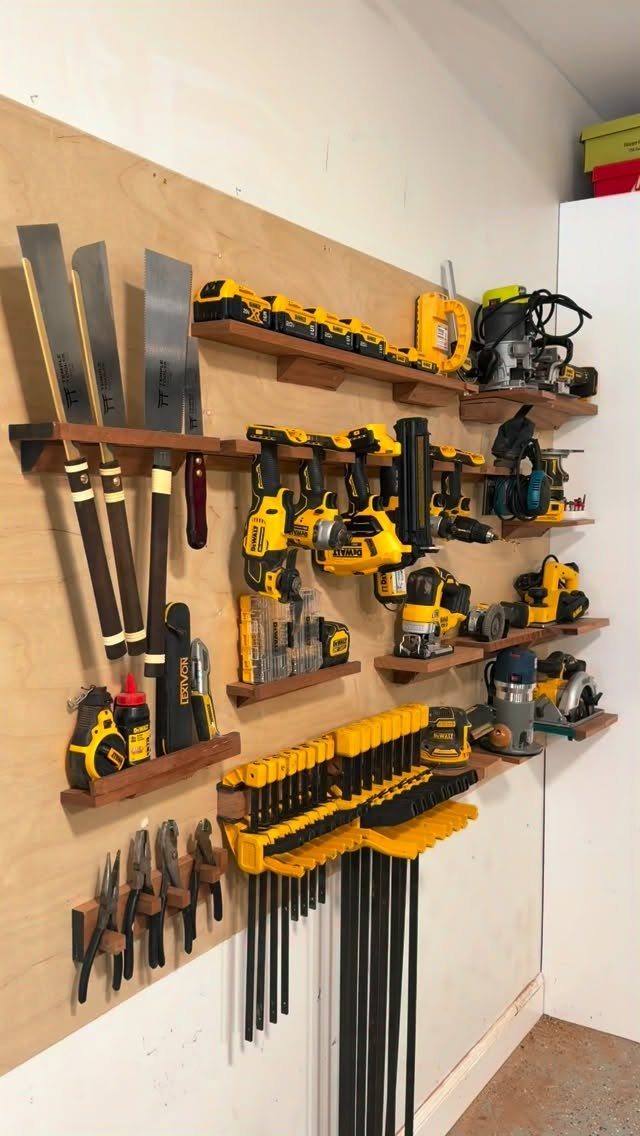 Tool Wall Storage: 8 Ideas for Garage and Workshop 9 Yellow power tools and hand saws organized on wooden shelves attached to a plywood workshop wall.