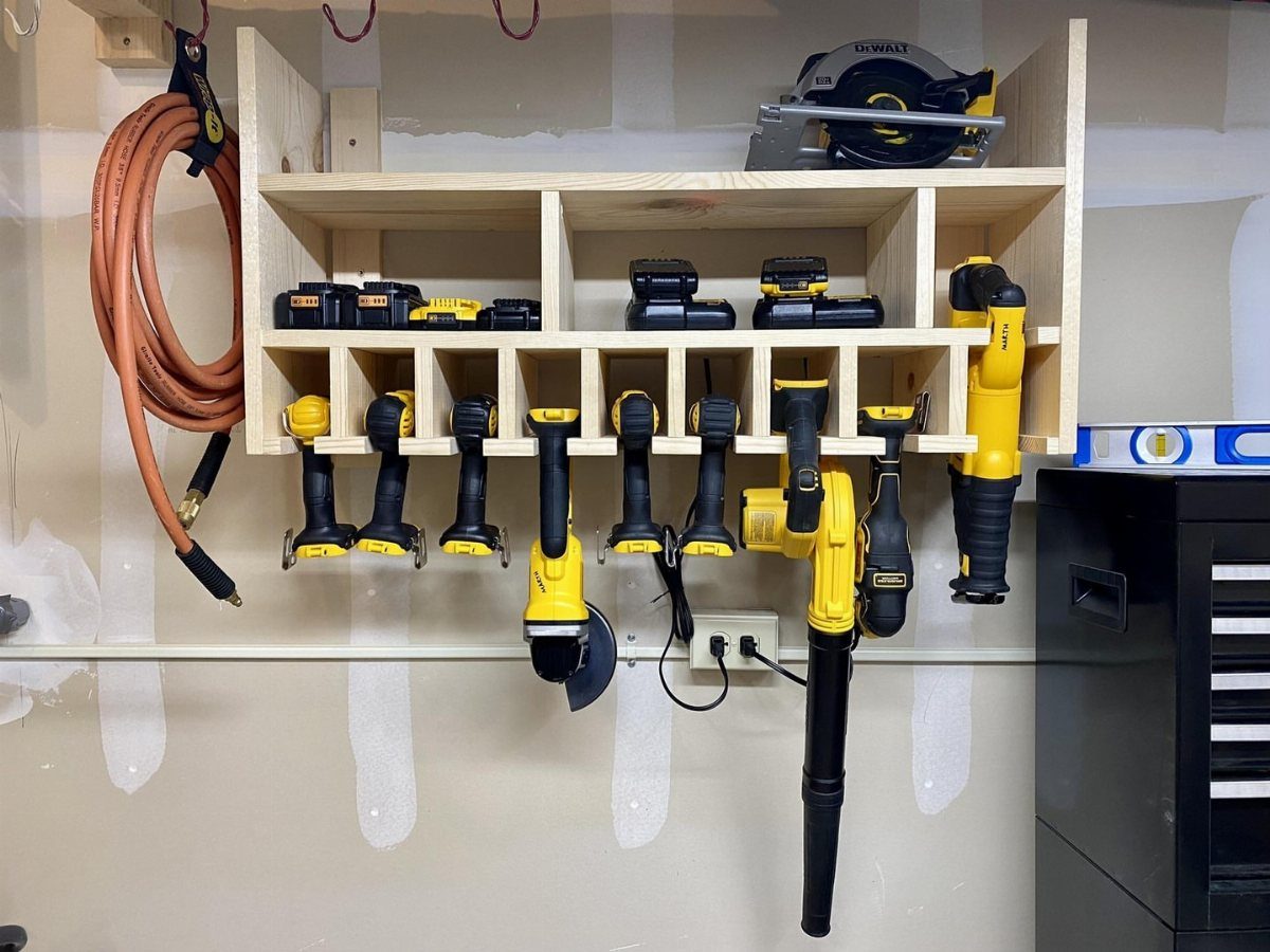 Tool Wall Storage: 8 Ideas for Garage and Workshop 3 Wooden wall-mounted shelving unit organized with various yellow and black power tools and an orange hose.