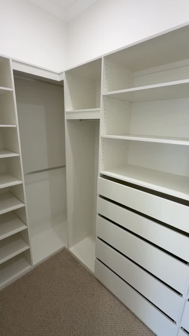 Walk in Closet Storage: 9 Ideas That Work in Real Homes 3 White built-in closet storage with adjustable shelving and multiple wide drawers in a bright room.