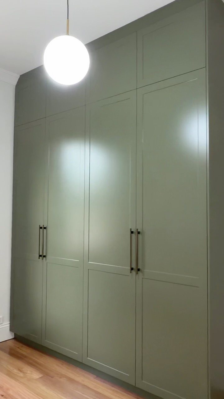 14 Wardrobe Interior Design Ideas for Every Bedroom 7 Sage green built-in wardrobes with long dark handles installed from floor to ceiling.