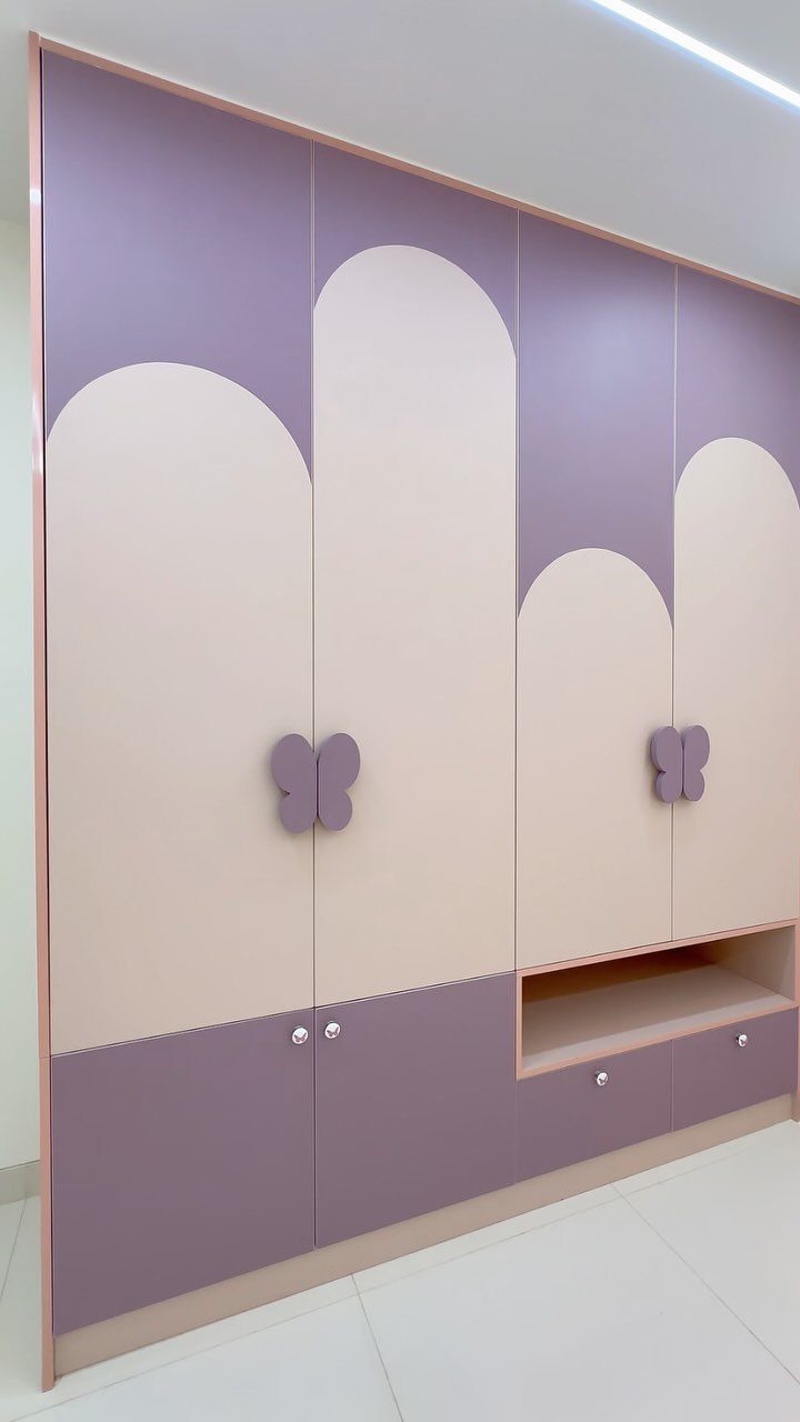14 Wardrobe Interior Design Ideas for Every Bedroom 13 A purple and cream built-in wardrobe with arched door designs and butterfly handles.